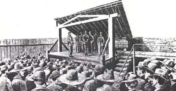 The platform for hanging criminals at Fort Smith appears to be a permanent structure. In this illustration, there are about 7 men standing behind the fellow to be hung.