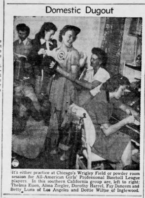 The baseball team is photographed in teh locker room, perhaps getting ready for a game.
