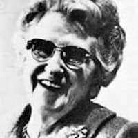 This is a newspaper photo of Eleanor Johnson, the long-time editor in chief of My Weekly Reader. She smiles and seems to be enjoying something.