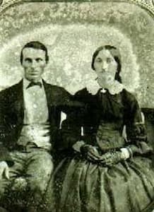 This is a 19th century grainy photograph of Peter and Elizabeth Thorn, sitting side-by-side. They are in