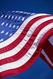 The U.S. flag waving against a blue sky.