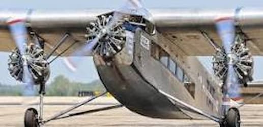 This color photograph of the Ford Trimotor shows the blades of the three motors spinning. You can also see the windows through which passengers could have looked out.