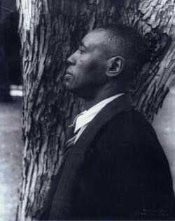 A photo in profile of a middle-aged Horace Pippin
