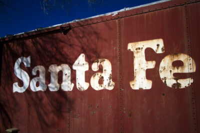A vintage red "Santa Fe" train car in the Rail Yard district.