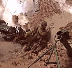 This is a sepia-toned photograph of a Army soldier writing "Kilroy Was Here" on a wall standing amidst rubble.