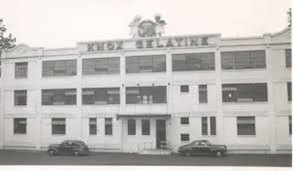 The building logo sits on the roof and features the calf's head with a white child and a Black child on either side.