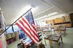 This photograph shows an American classroom where the flag is proudly displayed.