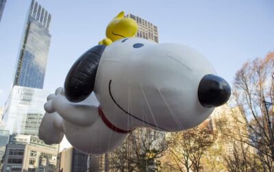 The giant Snoopy balloon with Woodstock on his head, cruising comfortably down Central Park West in New York City.
