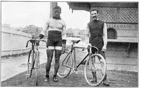 Major Taylor standing with fellow biker. Casual photo from newspaper