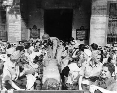 Army nurses at rescue. Chaotic scene as they prepare to leave Manila