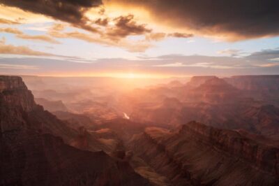 This is a sunset picture of the Grand Canyon from the South Rim. The clouds hang beautifully over the setting sun, and the light plays nicely on the canyon below.