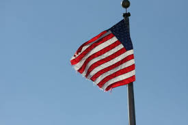 American flag flying against a blue sky. istockimages