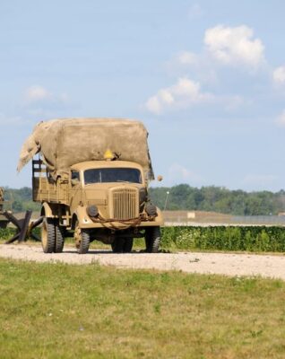 This is a color photograph of a Jimmy on the road that appears to be empty.