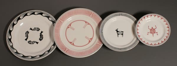 Four plates are pictured. three of them use a stylized animal as the main center feature. They are in red and blue.